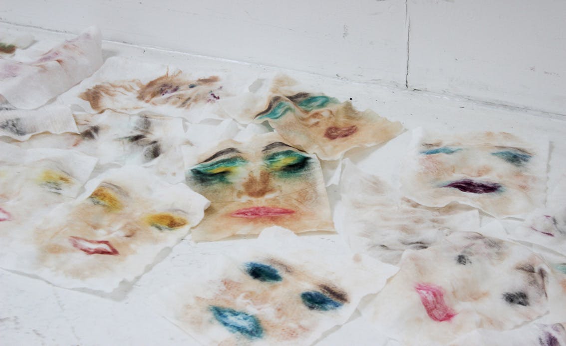 Scattered rectangular pieces of fabric with smudged images of faces on a white background work by Darcy for Testspace at Karst June 2021 Photos by Eloise Dodsworth