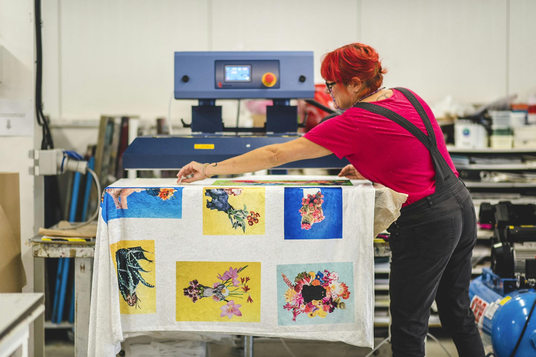 Lecturer Becky Dodman Wainwright uses the industrial heat press in textile studio to print cat and flowers design on fabric
