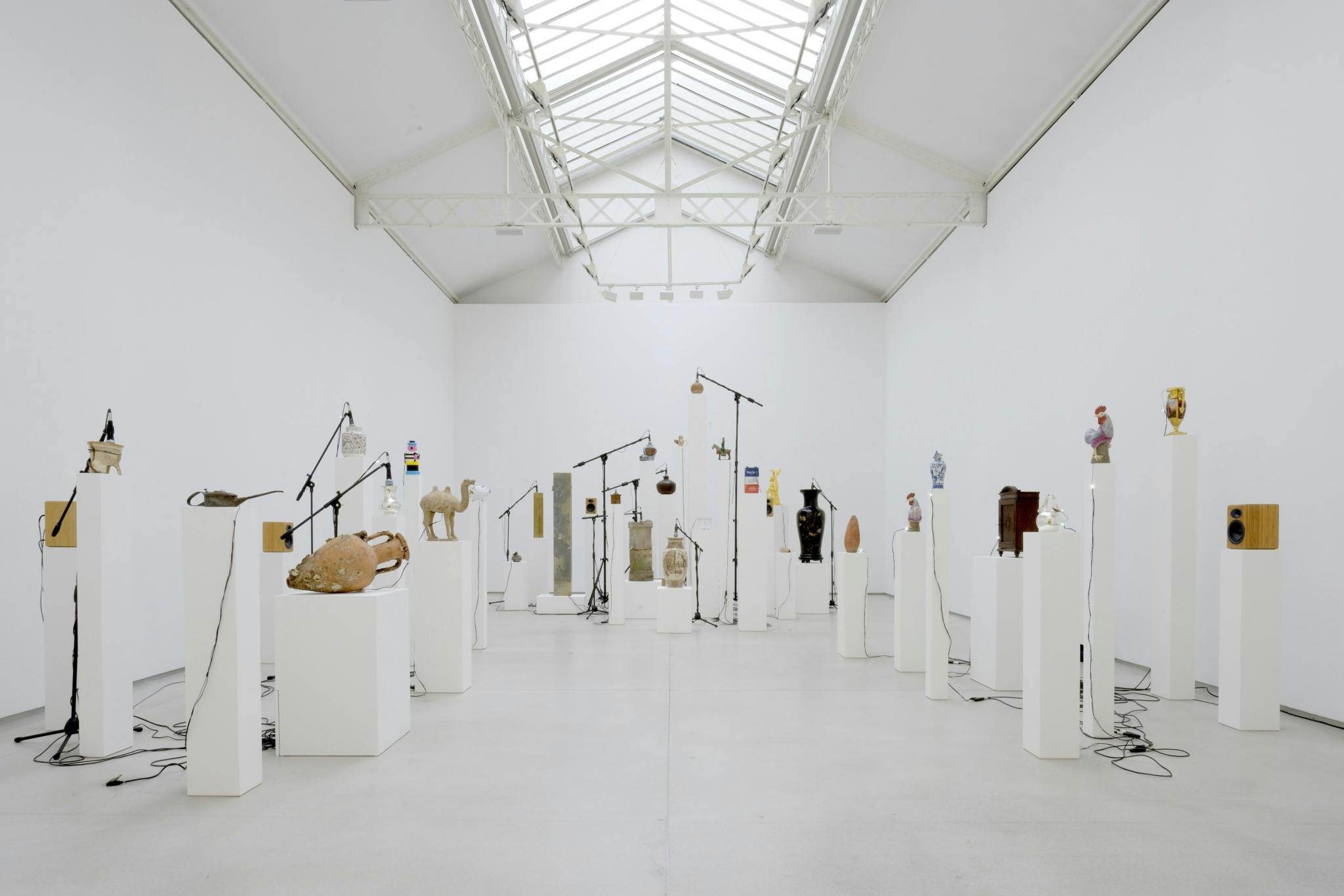 A white gallery space filled with the Household Gods installation by artist Oliver Beer, photographed by Charles Duprat.