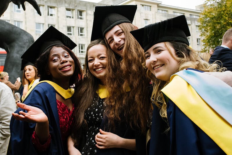 A group of happy smiling students posing for a photograph at our 2019 Graduation Ceremony