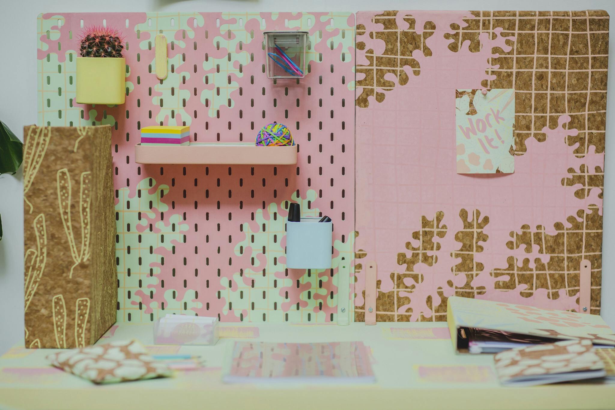 A pink desk with pastel coloured stationary