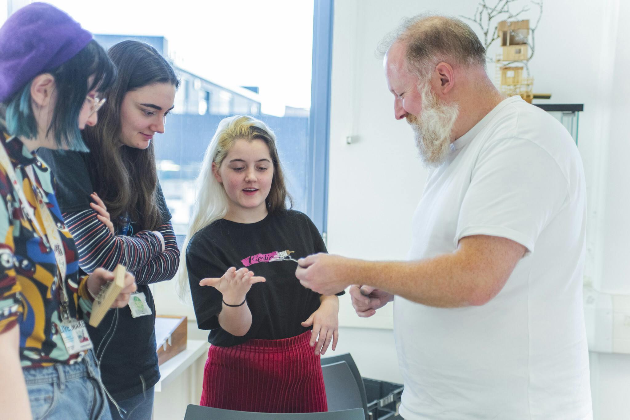 Animator Jim Parkyn, who has worked with Aardman Animations, shows three students how to create a clay character.