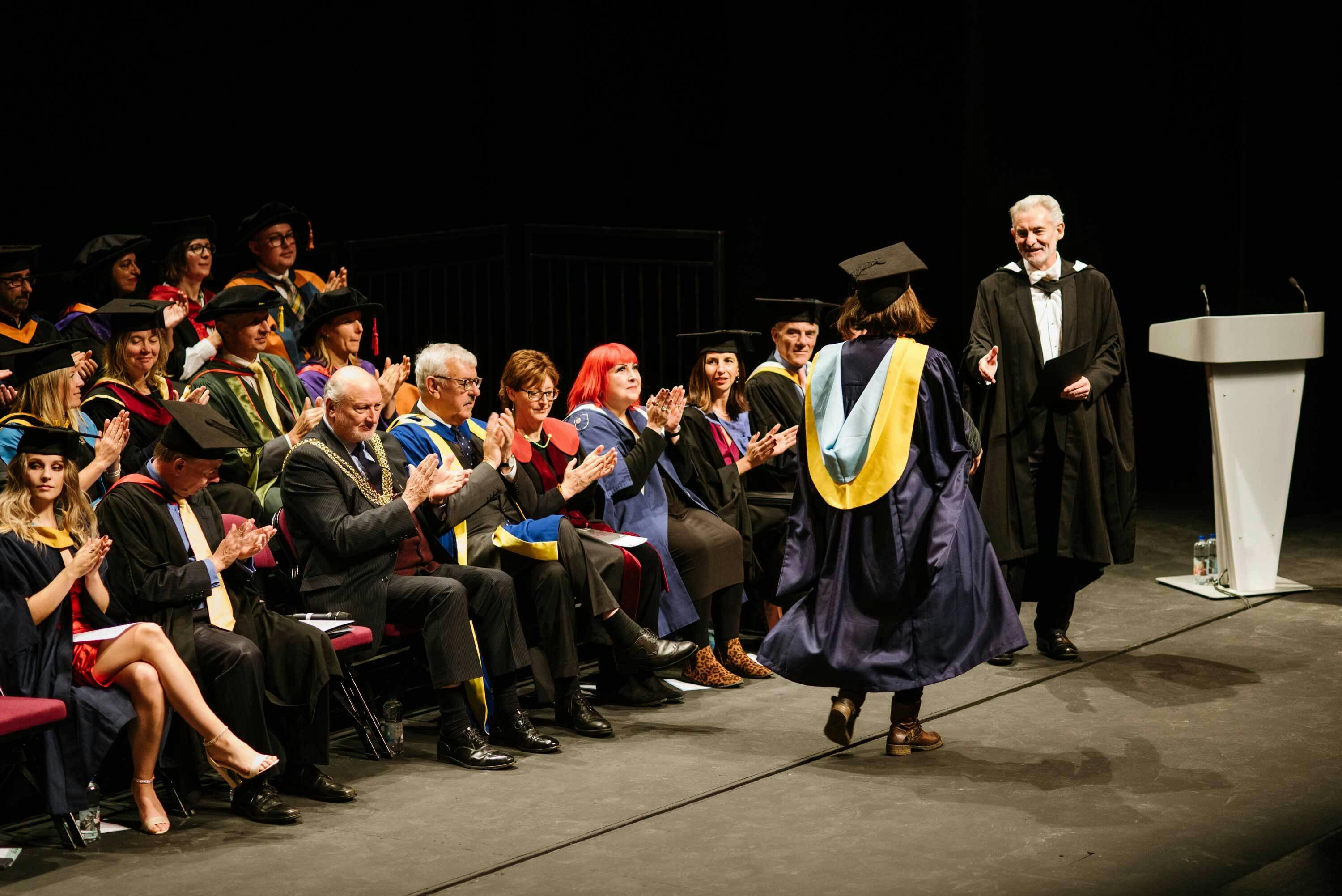 Andrew Brewerton congratulates graduating students