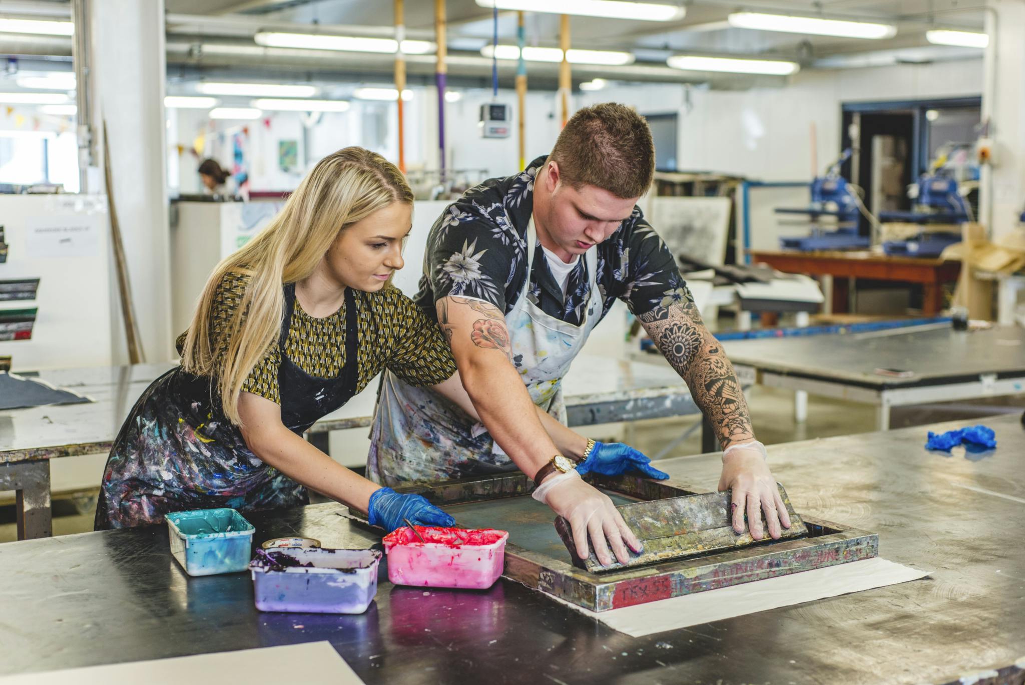 Two students work together to screen print