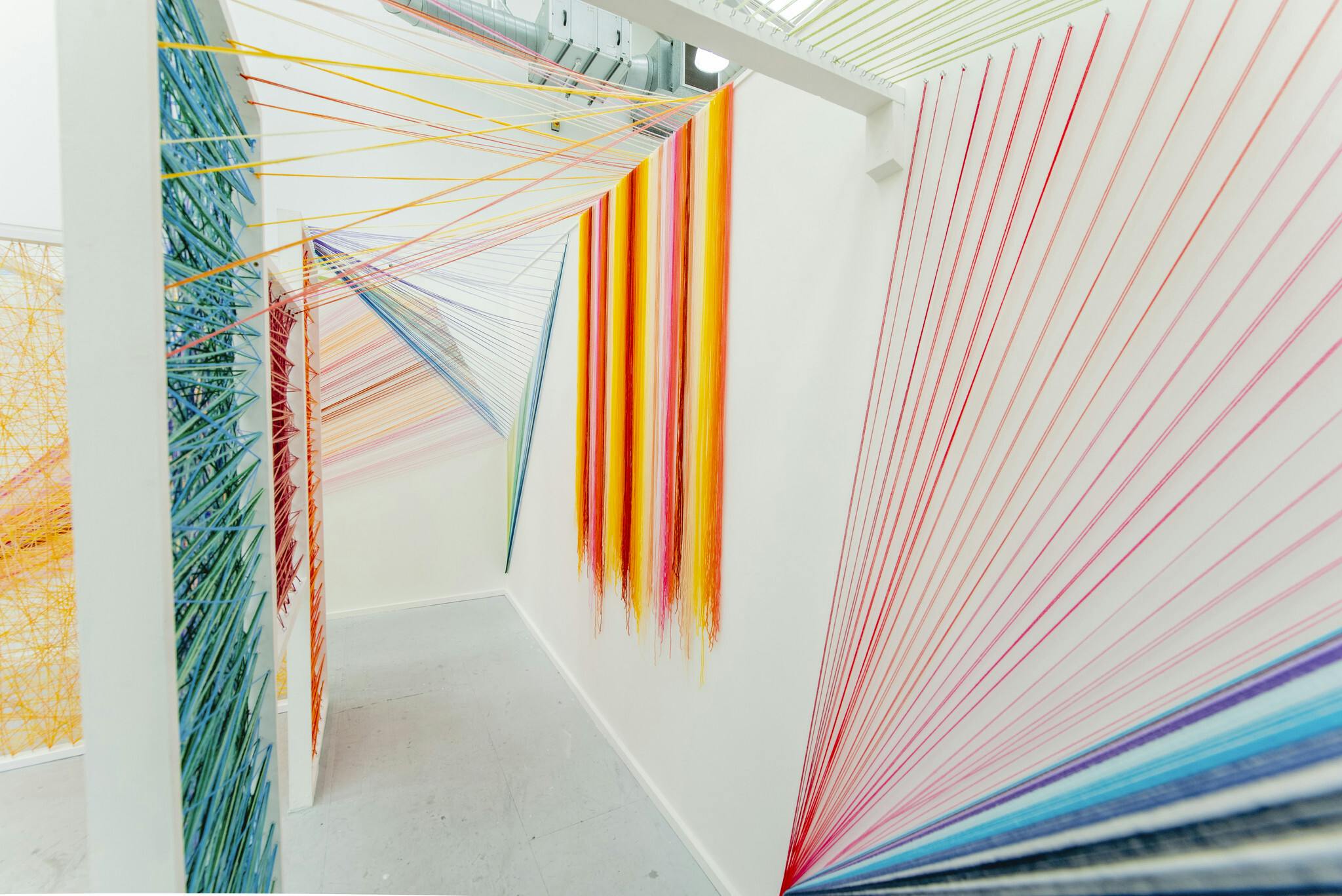 Plymouth College of Art Fine Art installation by Megan Caladwaldr using coloured wool stretched over frames and walls