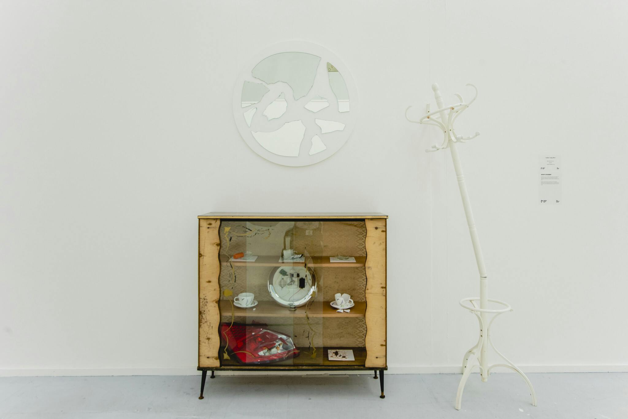 Plymouth College of Art Fine Art installation by Amber Lang-Beer featuring a dining room cabinet and broken home ware