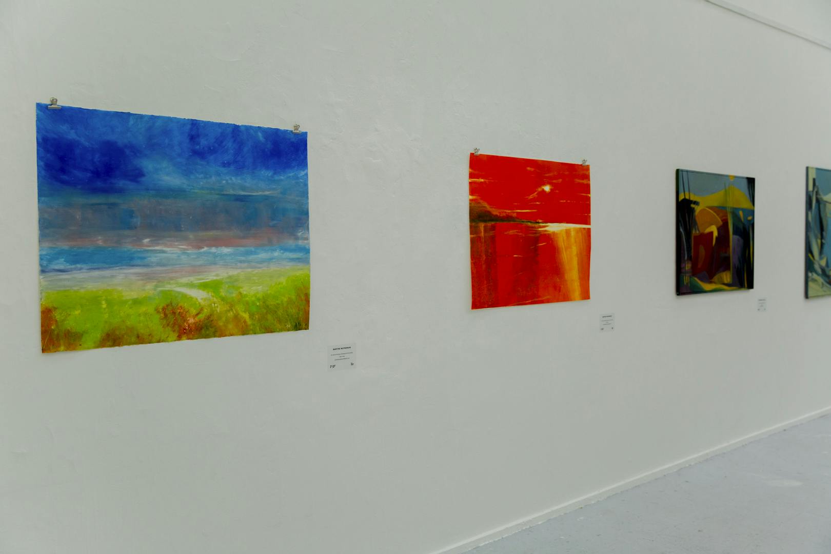 An image of Martine's exhibition featuring a number of colourful paintings