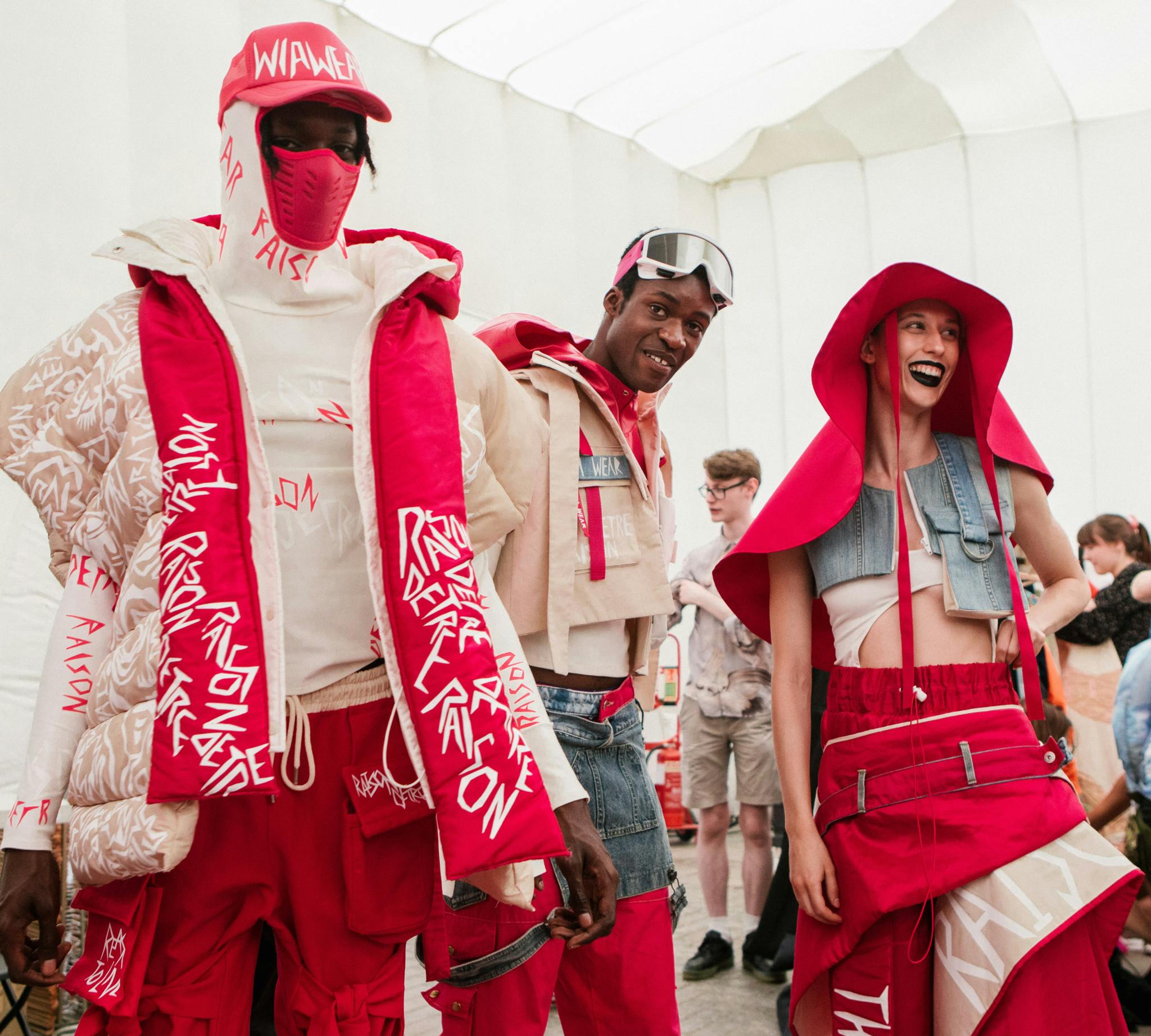 Two men and a woman model streetwear in red and white. The clothes feature bold graphics that are typical of MINSKI's aesthetic Oliwia Nowotnik Image by Rory James 16 1