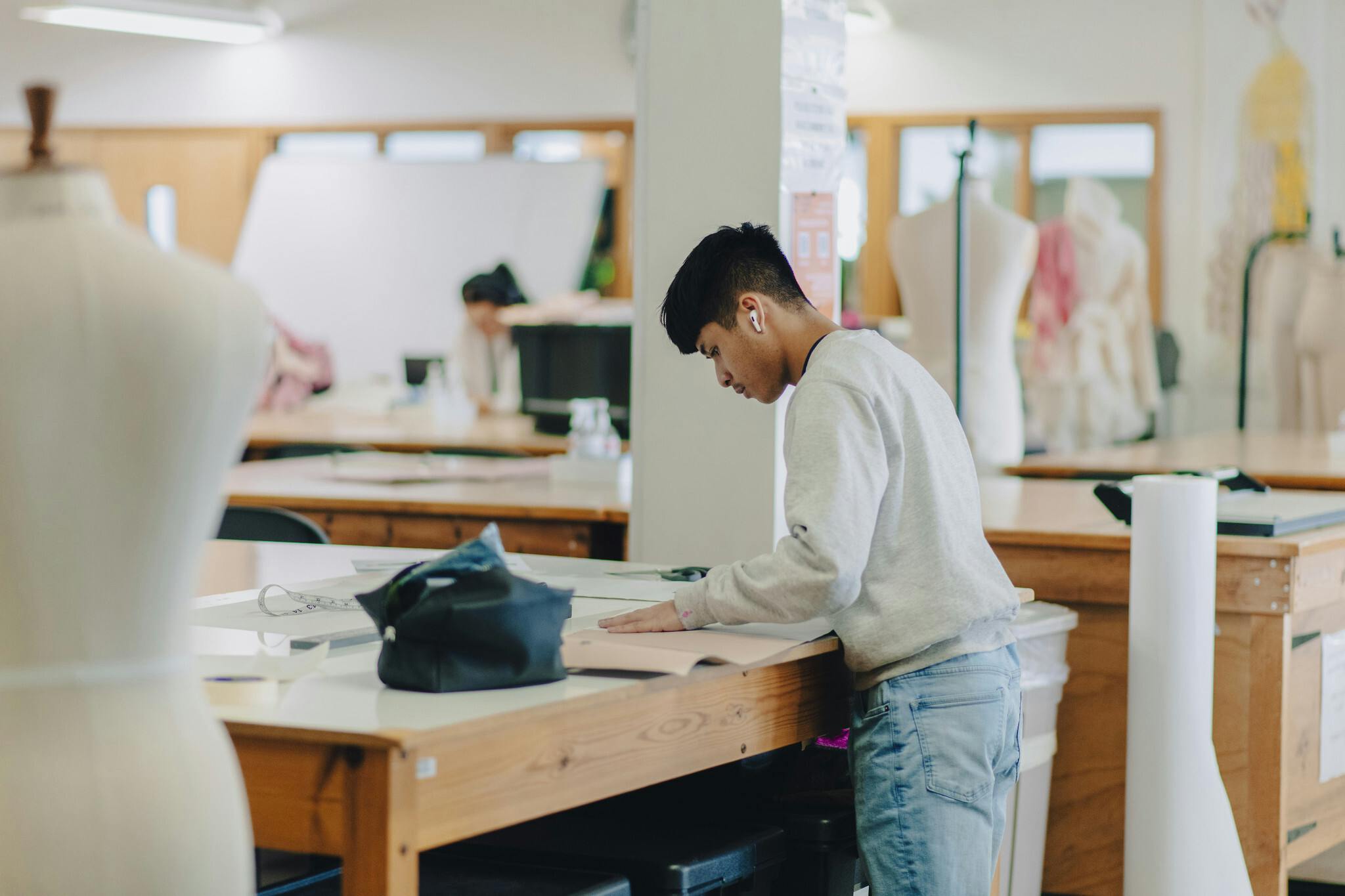 Male student working in the fashion studios
